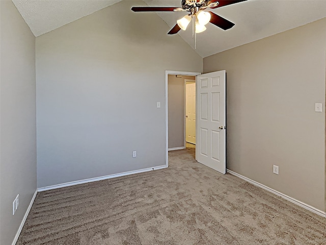 unfurnished bedroom with ceiling fan, baseboards, carpet, and lofted ceiling