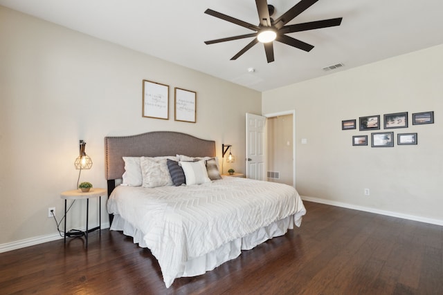 bedroom with wood finished floors, visible vents, and baseboards