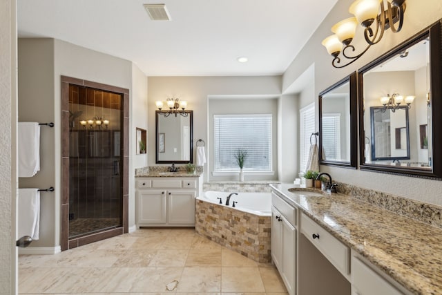 full bath featuring a sink, visible vents, and a notable chandelier