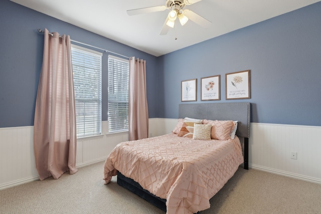 bedroom featuring wainscoting, ceiling fan, and carpet floors