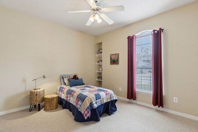 carpeted bedroom with a ceiling fan and baseboards