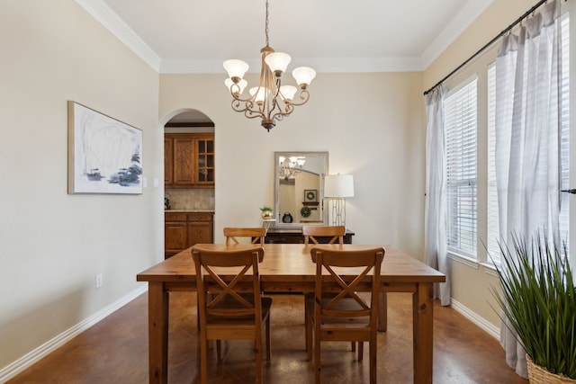 dining room featuring concrete floors, arched walkways, plenty of natural light, and an inviting chandelier