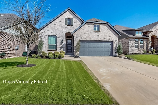 french provincial home featuring brick siding, an attached garage, concrete driveway, and a front yard