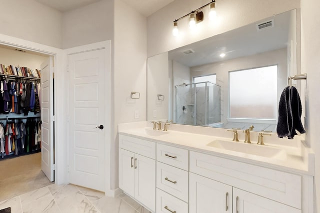 529 Hummingbird Dr, Celina, TX 75009 - bathroom with a sink, a stall shower, a walk in closet, double vanity, and visible vents