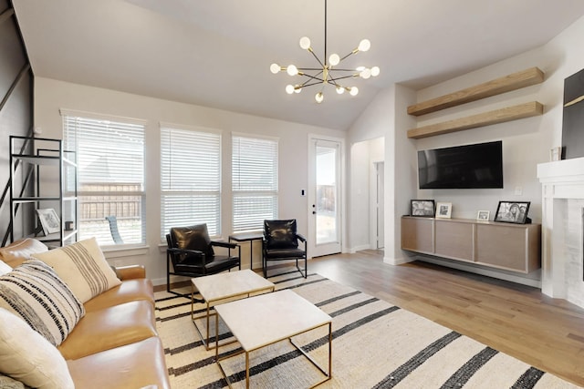529 Hummingbird Dr, Celina, TX 75009 - living area featuring lofted ceiling, a notable chandelier, wood finished floors, and plenty of natural light