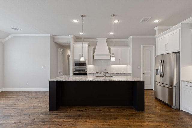 kitchen with premium range hood, visible vents, a sink, backsplash, and stainless steel appliances