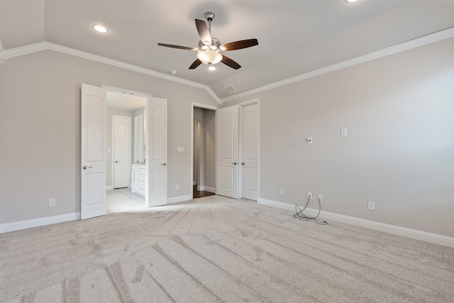 unfurnished bedroom featuring visible vents, crown molding, baseboards, light colored carpet, and lofted ceiling