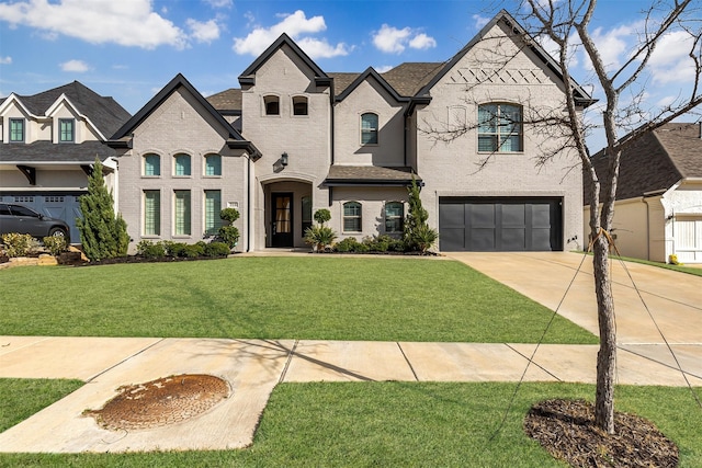 french country style house featuring a front lawn, an attached garage, brick siding, and driveway