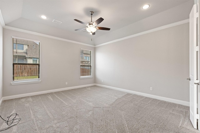 empty room featuring visible vents, a ceiling fan, carpet floors, crown molding, and baseboards