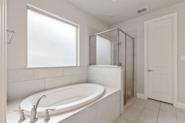 full bath featuring tile patterned flooring, visible vents, a shower stall, and a garden tub