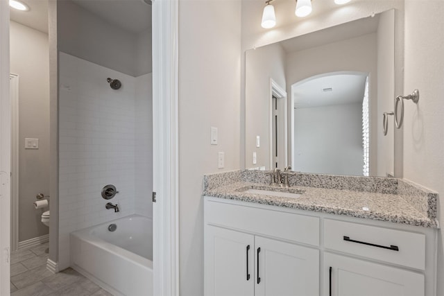 full bathroom with vanity, shower / tub combination, toilet, and baseboards