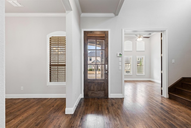 entryway with visible vents, dark wood-type flooring, crown molding, baseboards, and ceiling fan