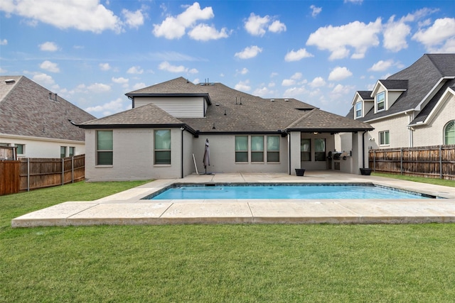 view of pool with a lawn, a fenced backyard, and a fenced in pool