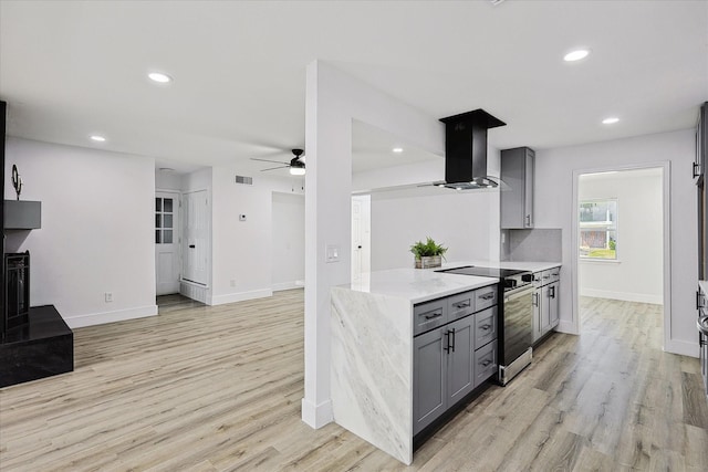 kitchen with ventilation hood, a ceiling fan, gray cabinetry, stainless steel range with electric stovetop, and light wood-type flooring