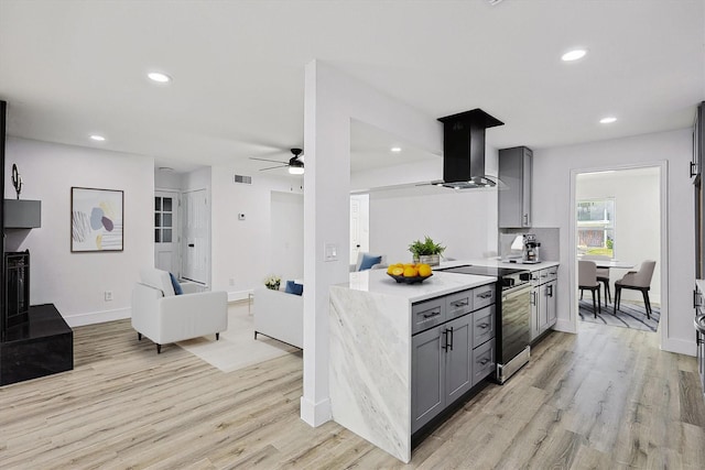 kitchen featuring range hood, a ceiling fan, stainless steel electric range, gray cabinetry, and light countertops