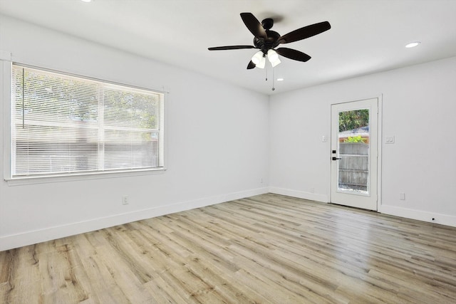 empty room featuring a ceiling fan, recessed lighting, wood finished floors, and baseboards