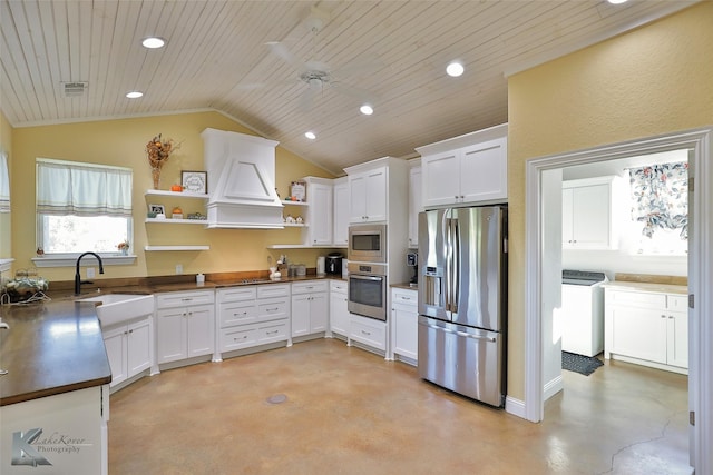 kitchen featuring premium range hood, a sink, open shelves, finished concrete flooring, and stainless steel appliances