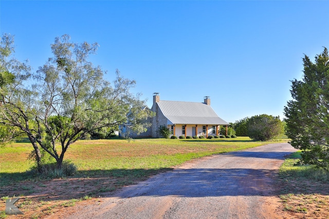 782 Bell Plains Rd, Tuscola, TX 79562 - back of house featuring covered porch, metal roof, a chimney, central AC unit, and a yard