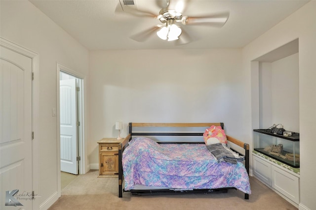 bedroom featuring baseboards, light carpet, visible vents, and a ceiling fan