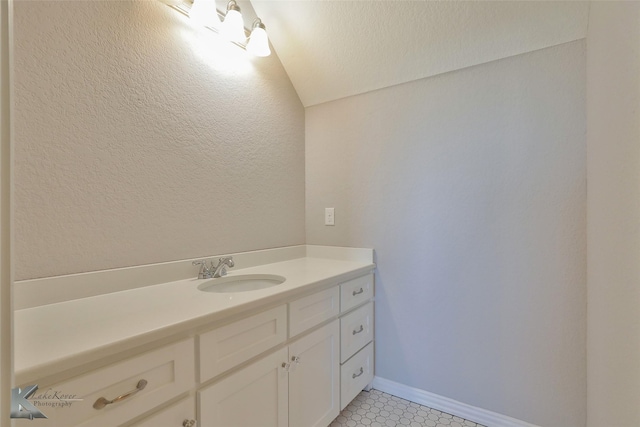 bathroom with vanity and baseboards