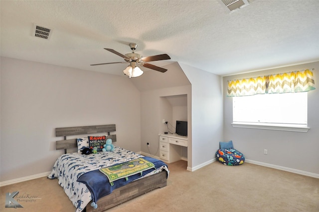 bedroom featuring visible vents, a textured ceiling, and carpet flooring