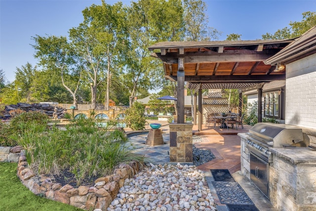 view of patio / terrace with area for grilling, a pergola, fence, outdoor dining area, and an outdoor kitchen