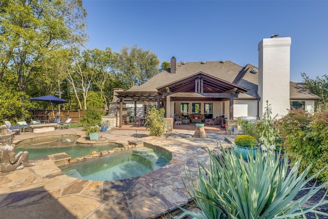 view of pool with an outdoor living space, fence, a patio area, an in ground hot tub, and a pergola