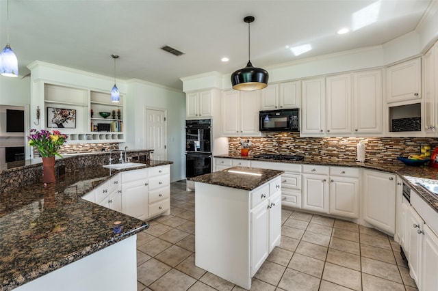 kitchen with visible vents, a kitchen island, a sink, black appliances, and crown molding