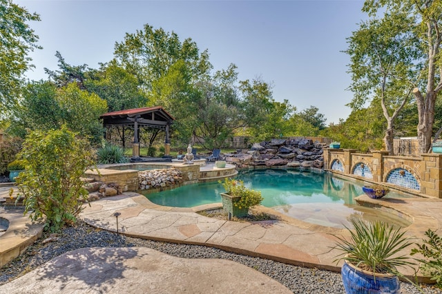 pool with a gazebo and an in ground hot tub