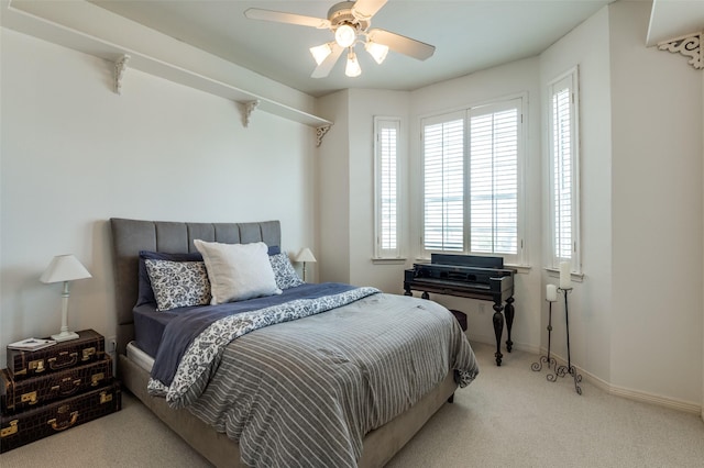 bedroom with baseboards, carpet floors, and a ceiling fan