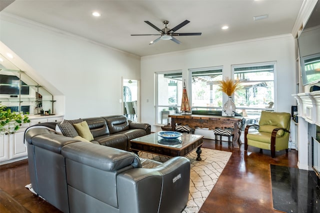 living area featuring concrete floors, ceiling fan, ornamental molding, recessed lighting, and a fireplace