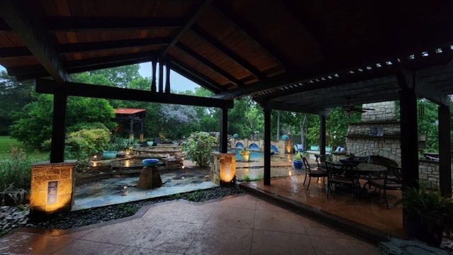 view of patio / terrace with a gazebo, outdoor dining area, and ceiling fan