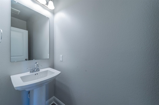 bathroom with a sink and visible vents