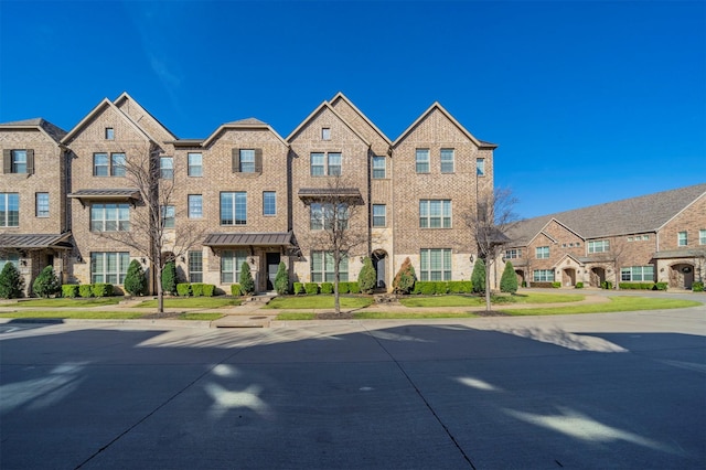 multi unit property featuring brick siding and a residential view