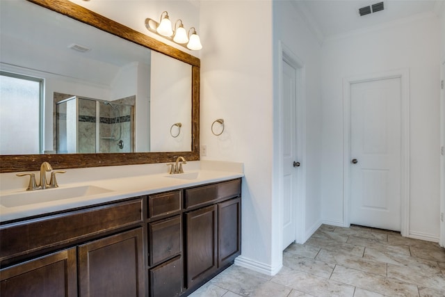 full bath with double vanity, visible vents, a shower stall, and a sink