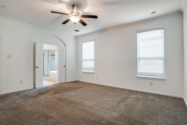 spare room featuring crown molding, carpet flooring, a ceiling fan, and visible vents