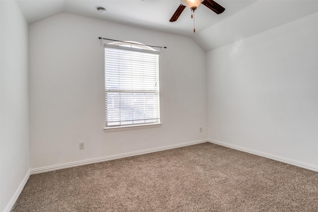 carpeted empty room with baseboards, ceiling fan, and vaulted ceiling