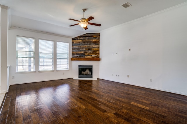 unfurnished living room featuring hardwood / wood-style floors, a ceiling fan, visible vents, a fireplace, and crown molding