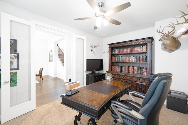 office space featuring wood finished floors, a ceiling fan, baseboards, and french doors