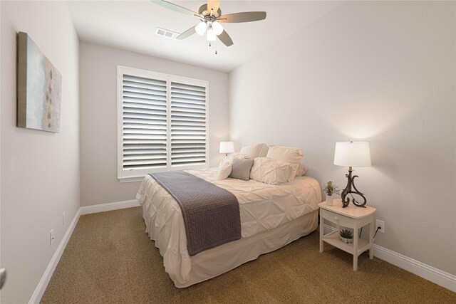 carpeted bedroom featuring baseboards, a ceiling fan, and visible vents