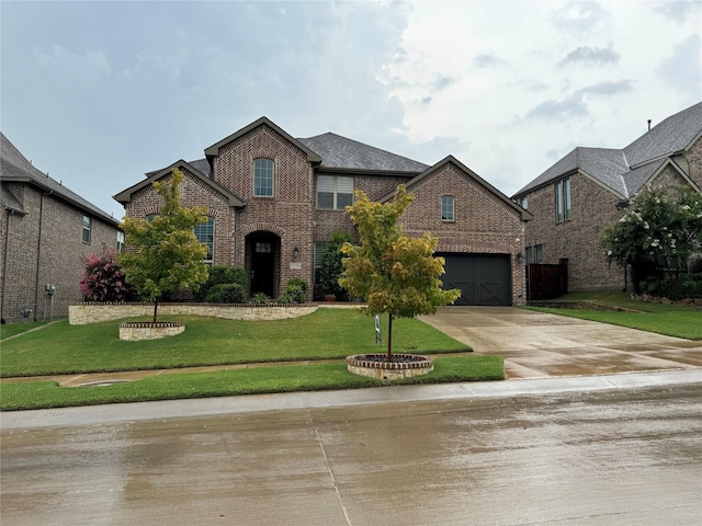 traditional-style home with a front lawn, a garage, brick siding, and driveway