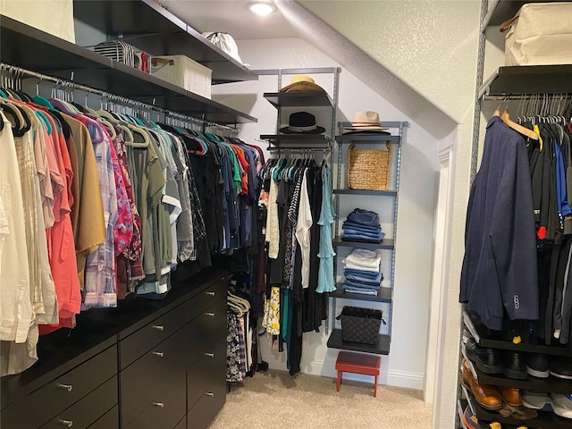 walk in closet featuring light carpet