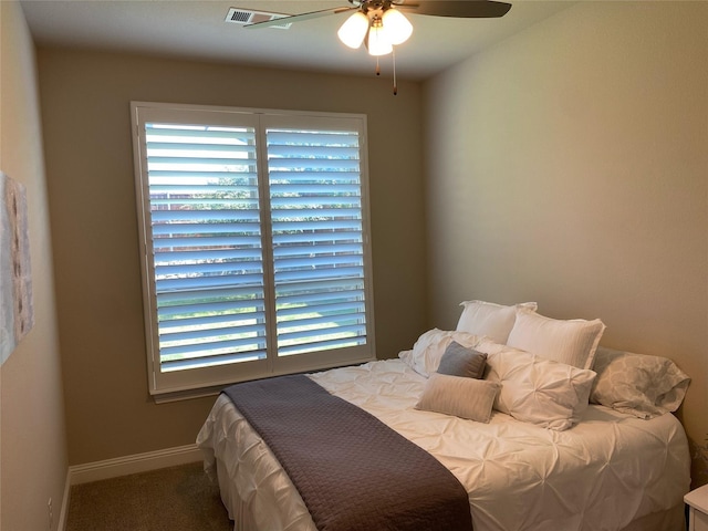 bedroom featuring multiple windows, carpet, baseboards, and ceiling fan