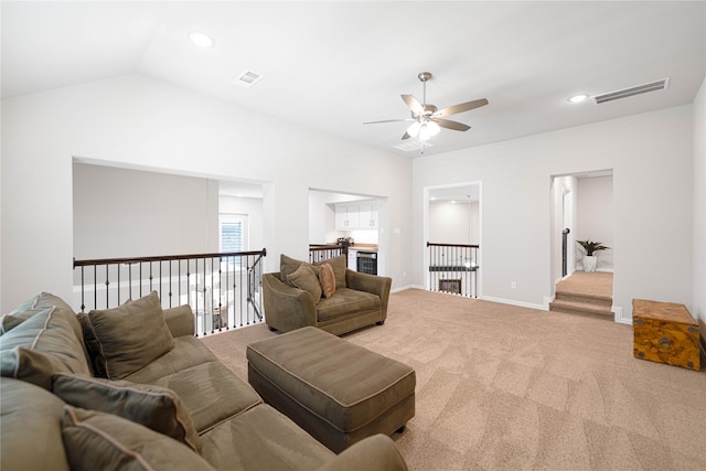 carpeted living room with a ceiling fan, visible vents, and recessed lighting