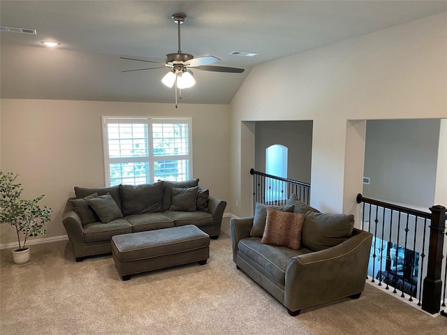 living area featuring lofted ceiling, light colored carpet, visible vents, and ceiling fan