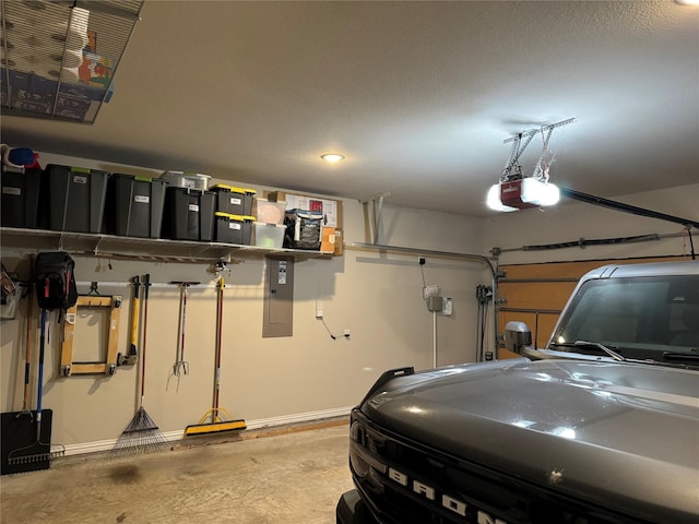 garage featuring electric panel and a garage door opener