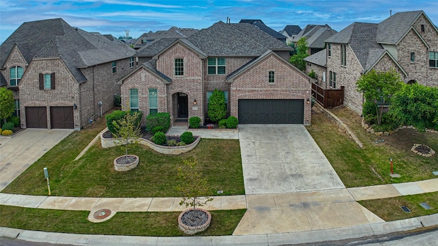view of front of property with brick siding, driveway, and a front yard