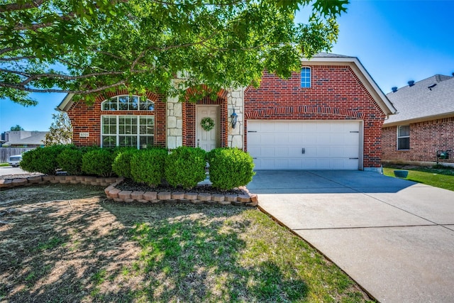 view of front of house with concrete driveway, an attached garage, and brick siding