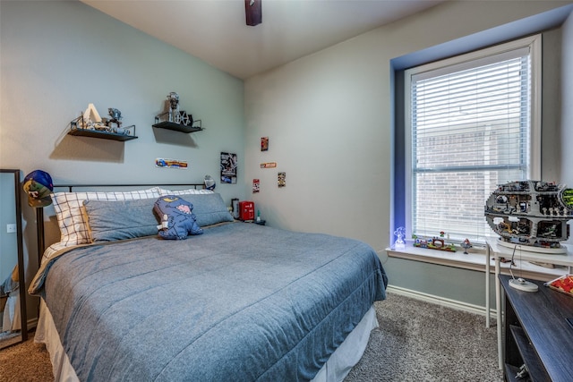 carpeted bedroom with multiple windows, a ceiling fan, and baseboards