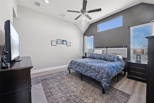 bedroom with visible vents, lofted ceiling, and wood finished floors